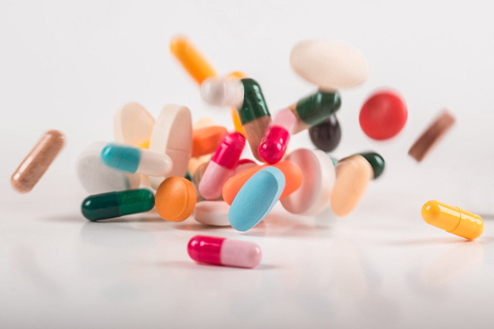Pharmacy background on white background. Levitation pills. Tablets on white background which falling down. Pills. Medicine and healthy. Close up of capsules. Differend kind of pills