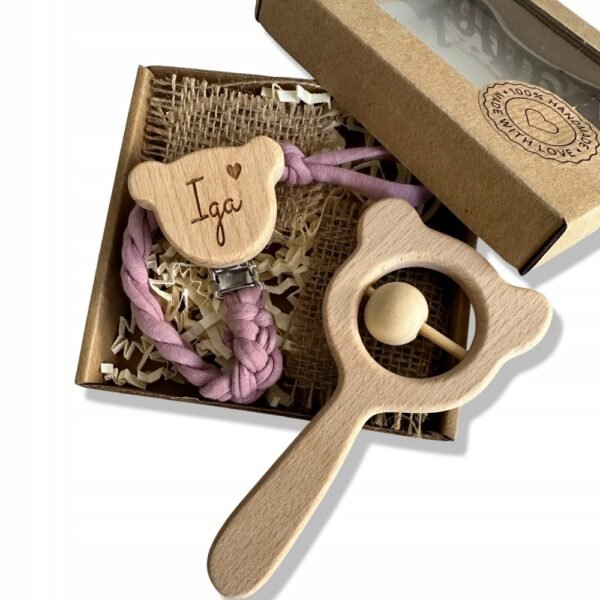 Customizable braided pacifier pendant featuring name engraving, paired with a charming baby shower rattle. Ideal for gifting and keeping pacifiers secure.