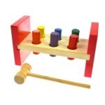 A wooden educational game featuring a pestle, hammer, and beater, designed to develop hand-eye coordination, motor skills, and problem-solving abilities in children.